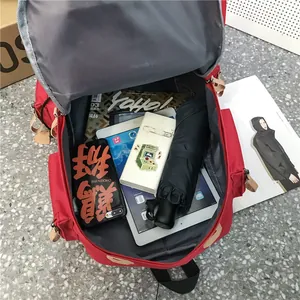 Red canvas backpack showing a large interior capacity for a laptop and daily essentials