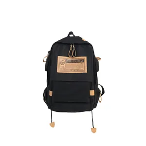 Large capacity black canvas backpack with brown leather accents and dual shoulder straps