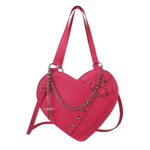 Pink heart-shaped tote bag with punk silver chains and metallic cross pendants