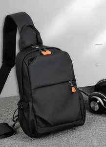Detail view of black waterproof nylon chest bag with orange zipper and side water bottle pocket