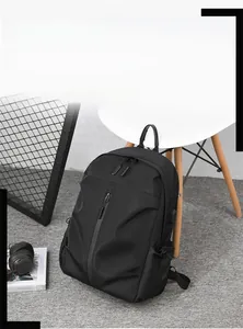 Minimalist black waterproof business backpack with vertical zip and side pockets