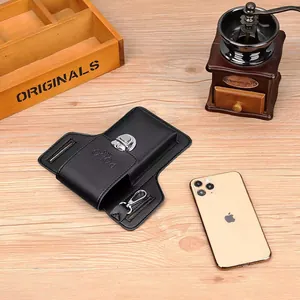 Detail of black leather phone holster with silver buckle and POLO logo on wood surface