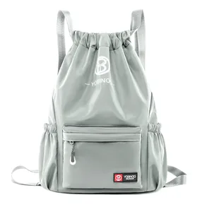 Grey large capacity drawstring backpack with front zip pocket for sports and gym use