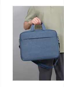 Sacoche ordinateur bleue avec poignée renforcée et détail de bandoulière amovible