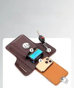 Detail of brown leather waist pouch with metal buckle, phone compartment and key hook