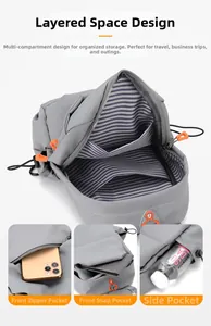 Detail view of grey crossbody bag featuring multi-layer compartments and side mesh pocket