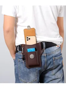 Detail of dark brown leather phone holster with belt loop and metal snap pocket