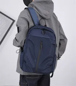 Detail of navy blue nylon laptop backpack showing matte texture and side water bottle pocket