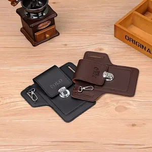 Close-up of leather phone belt pouches in black and brown with metal buckles