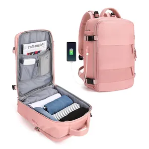 Pink travel backpack showing USB charging port and interior storage compartments