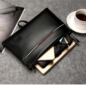 Detail view of large capacity black PU clutch bag interior holding tablet and phone