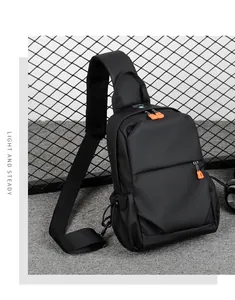 Detail of durable black chest bag with vibrant orange zipper and adjustable shoulder strap