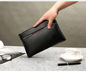 Close-up of black PU leather clutch bag featuring signature tricolor stripe detail