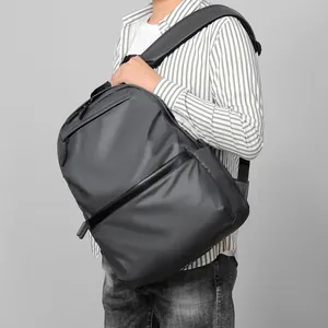 Water-resistant dark grey business backpack with premium matte finish and ergonomic straps