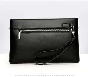 Detail of the back zipper pocket and matte leather texture on this men's clutch bag