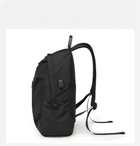 Detail view of black travel backpack side with USB charging port and mesh side pocket