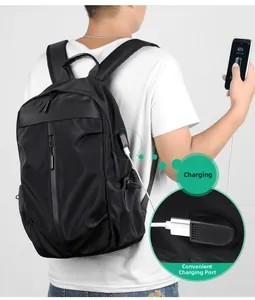 Detail of black backpack showing integrated USB charging port and cable connection