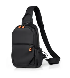 Detail view of black crossbody chest bag featuring vibrant orange zipper pulls and mesh strap