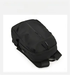 Detail view of black waterproof backpack featuring integrated USB charging port and zipper