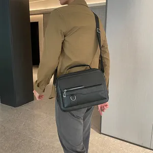 Close-up of black business briefcase featuring textured leather and silver D-ring detail