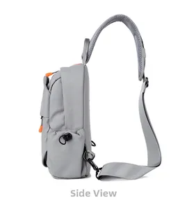 Side view of gray crossbody chest bag with orange zippers and mesh padded straps