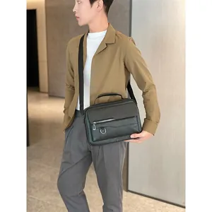 Detailed view of black matte leather men's business bag with adjustable shoulder strap