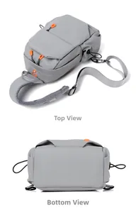 Detail view showing gray waterproof chest bag with orange zippers and mesh padded strap