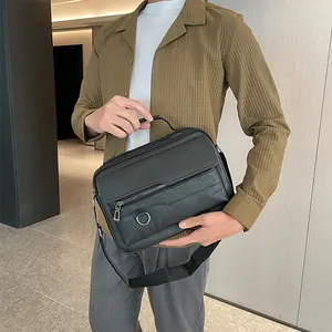 Detail of black business briefcase with silver D-ring and adjustable shoulder strap