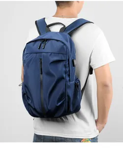 Close-up of a navy blue nylon backpack with side pockets and external USB charging port
