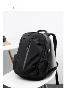 Close-up of waterproof black backpack showing USB charging port and sleek nylon texture