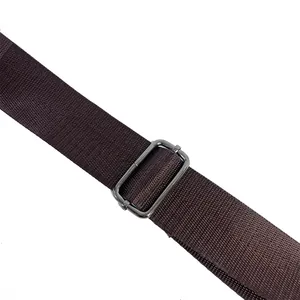 Detail of dark brown woven shoulder strap with metallic charcoal adjustable buckle