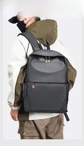 Détail du sac à dos en nylon imperméable gris foncé avec fermetures éclair orange