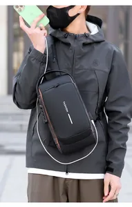 Detail of black anti-theft chest bag with USB port and secure combination lock