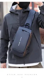 Detail of gray waterproof crossbody bag featuring a USB charging port and reflective strip