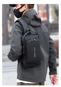 Close-up of black men's chest bag with anti-theft combination lock and USB charging port