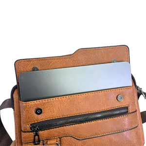 Close-up of brown faux leather bag showing荔枝 texture and tablet storage capacity