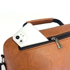 Detail of vintage brown leather briefcase with side zip pocket for smartphone storage