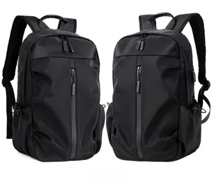 Close-up of black waterproof backpack featuring a vertical zipper pocket and USB charging port