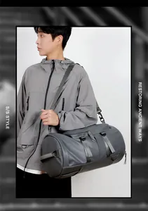 Detail of dark gray waterproof travel bag with adjustable strap and metal buckles