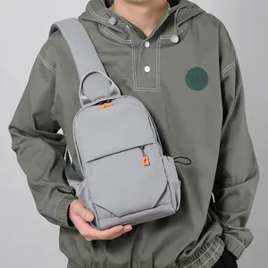 Men's light grey oxford chest bag with vibrant orange zippers and adjustable shoulder strap