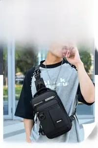 Detail of high-capacity black men's sling bag with durable oxford cloth and urban style