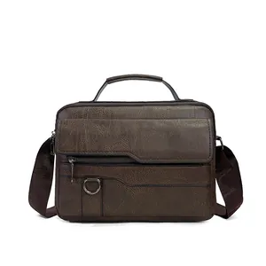 Detail of dark brown leather business bag with top handle and adjustable fabric strap