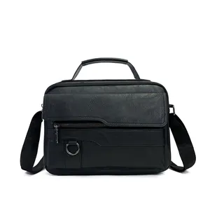 Detail of the black business messenger bag showing textured leather and metal hardware
