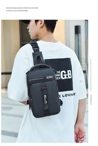 Detail view of durable black Oxford cloth chest bag with adjustable shoulder strap and zippers