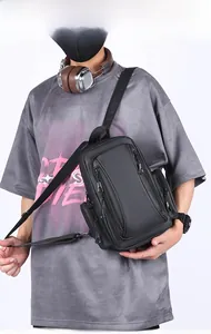 Detailed view of black waterproof nylon multi-pocket crossbody bag worn by a model