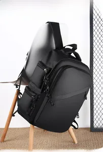 Detail of waterproof black business backpack with multi-zipper compartments on a white chair