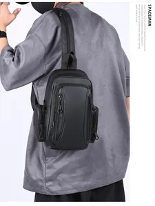 Rear side view of a waterproof black multi-pocket crossbody bag worn by a model