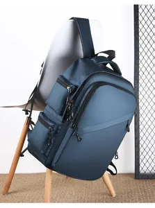 Detail of waterproof navy blue business backpack with multiple zipper pockets and wide straps