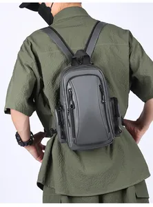 Detail view of a gray multifunctional waterproof chest bag worn by a model