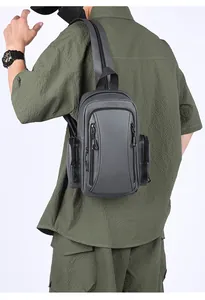 Waterproof grey crossbody bag with multiple pockets shown on a person for scale and fit